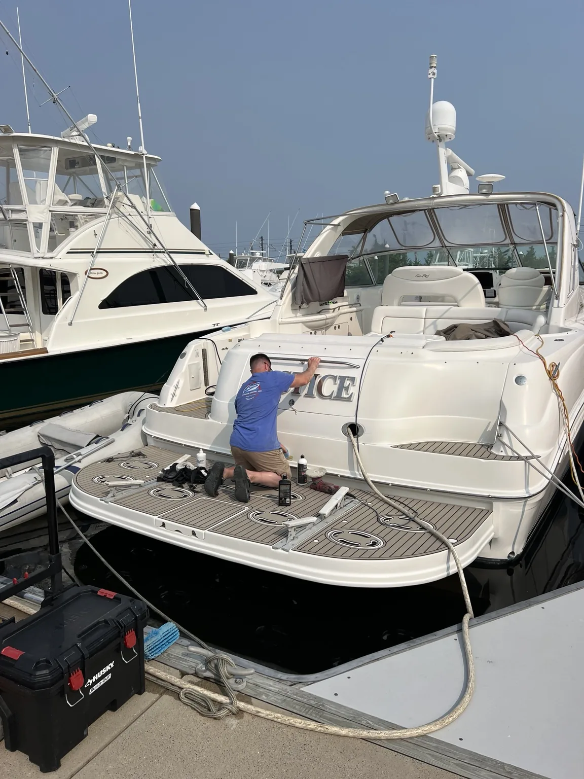 Superior Marine detailing and polishing the stern of a cruiser