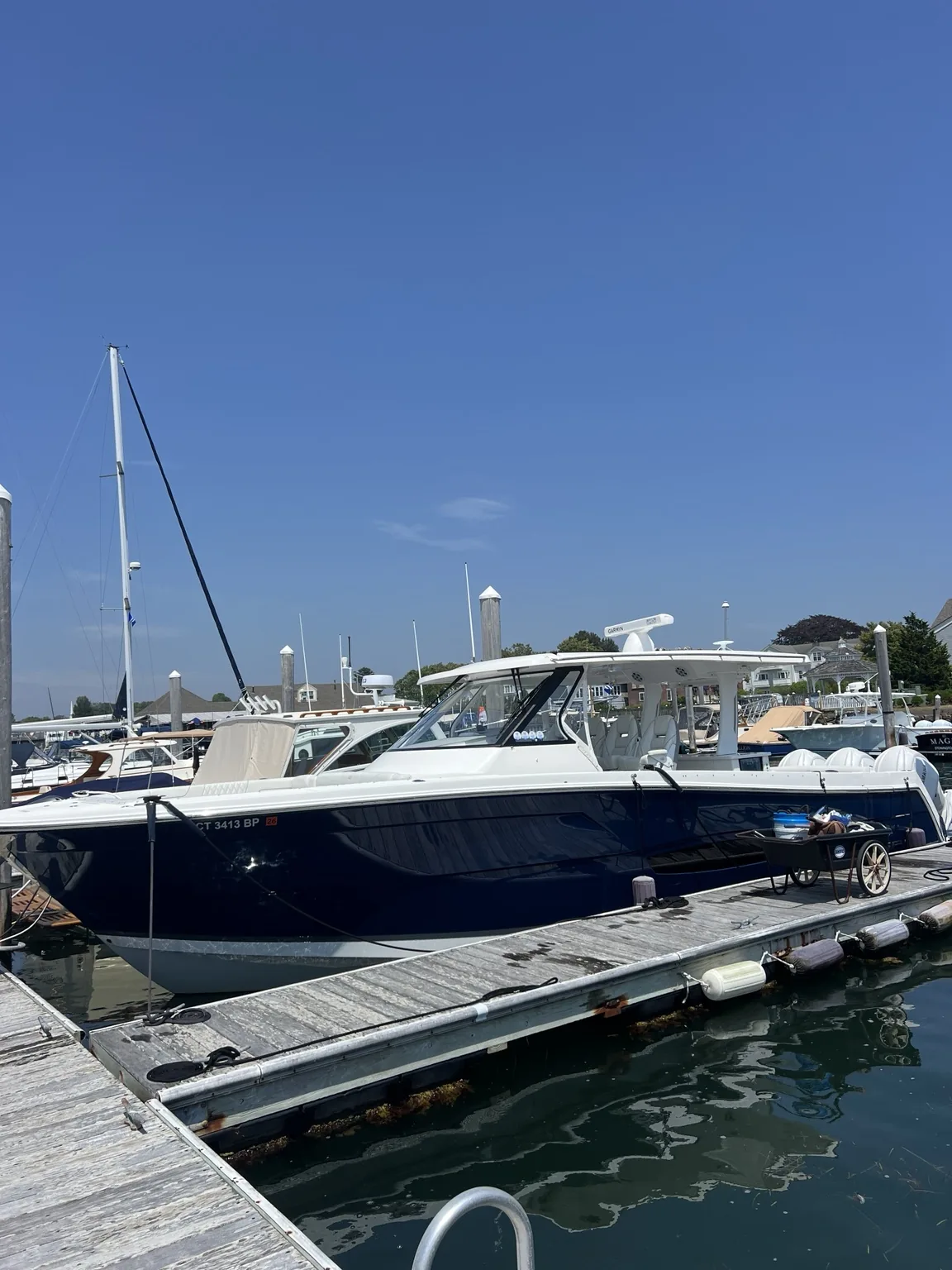 Detailed blue center console boat at a marina