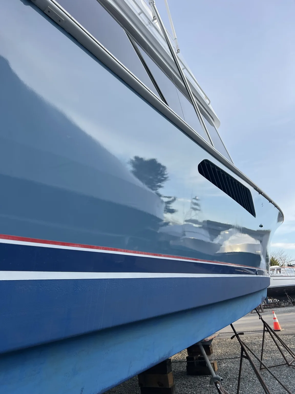 Deep gloss and reflection on a blue yacht hull