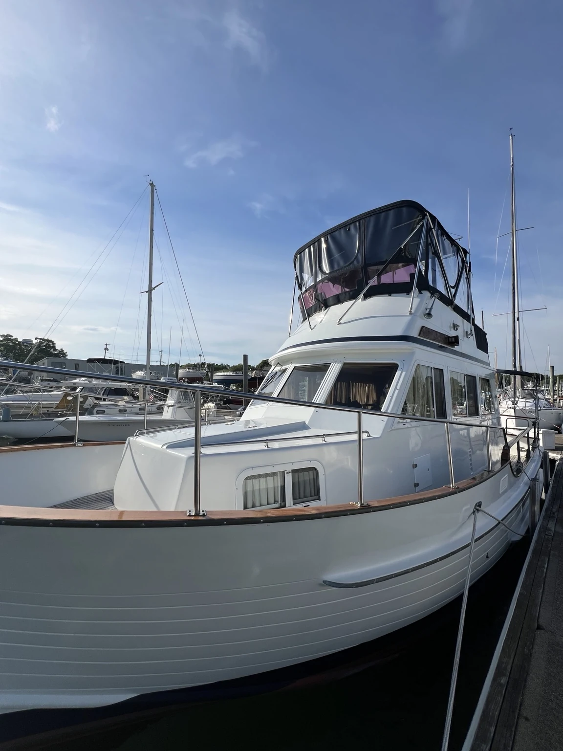 Classic white trawler-style motor yacht at the dock