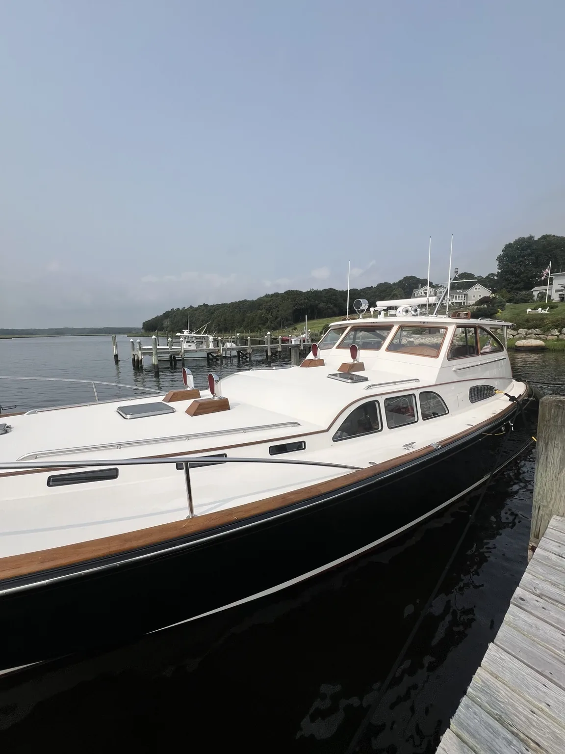 Classic dark-hulled yacht after detailing