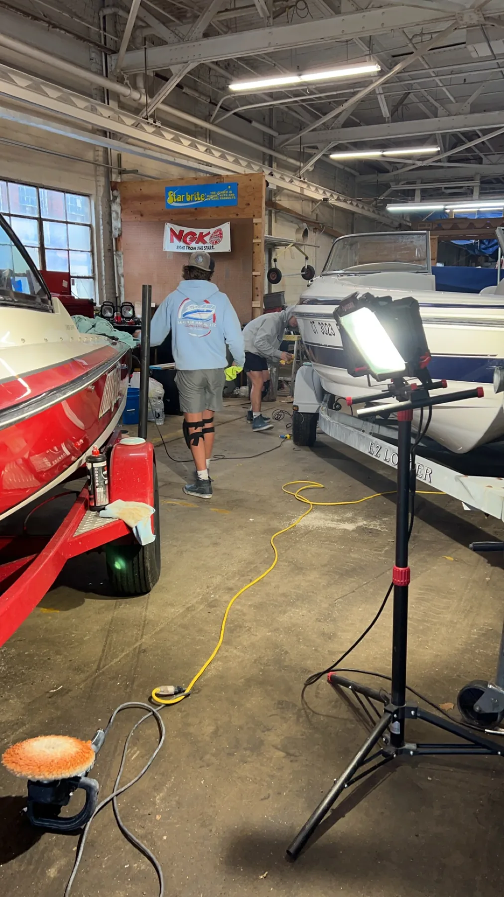 Superior Marine crew performing detailing work inside a marine shop