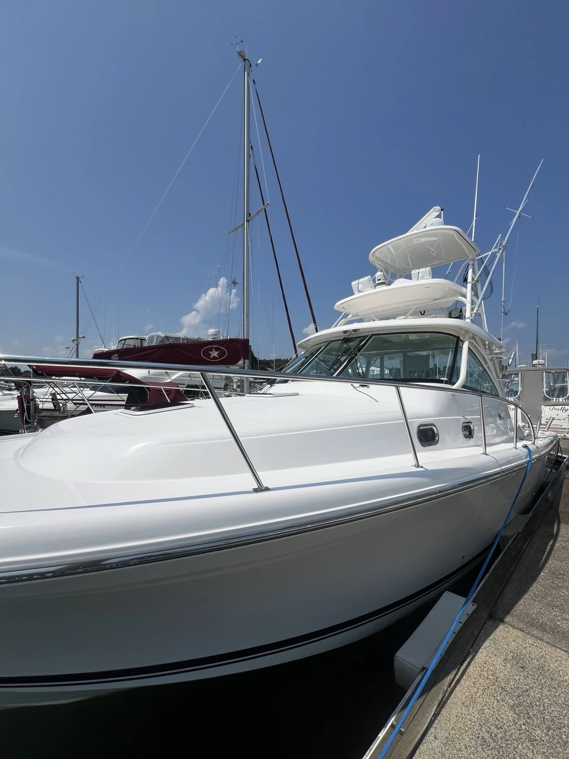 White hardtop express boat with tower and polished finish