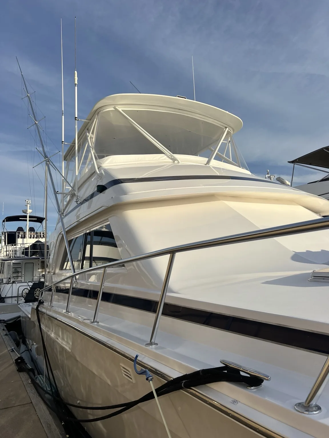 Large white sportfishing yacht at dock