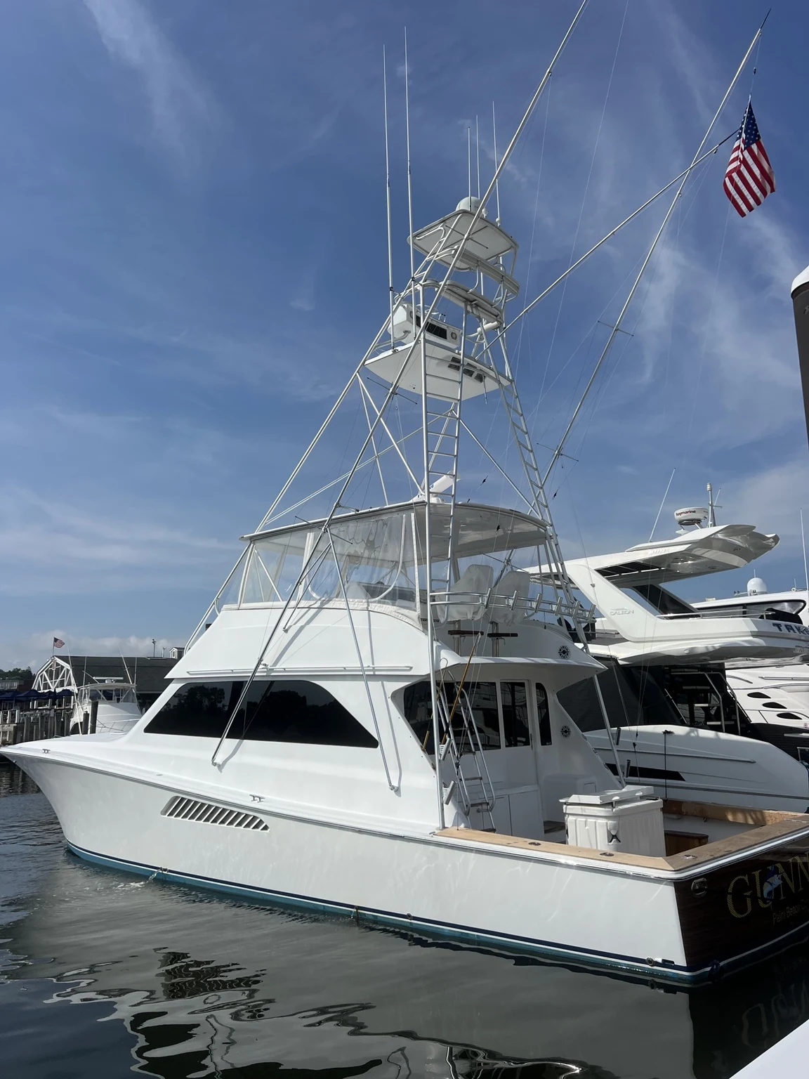 Large white sportfishing yacht with tuna tower